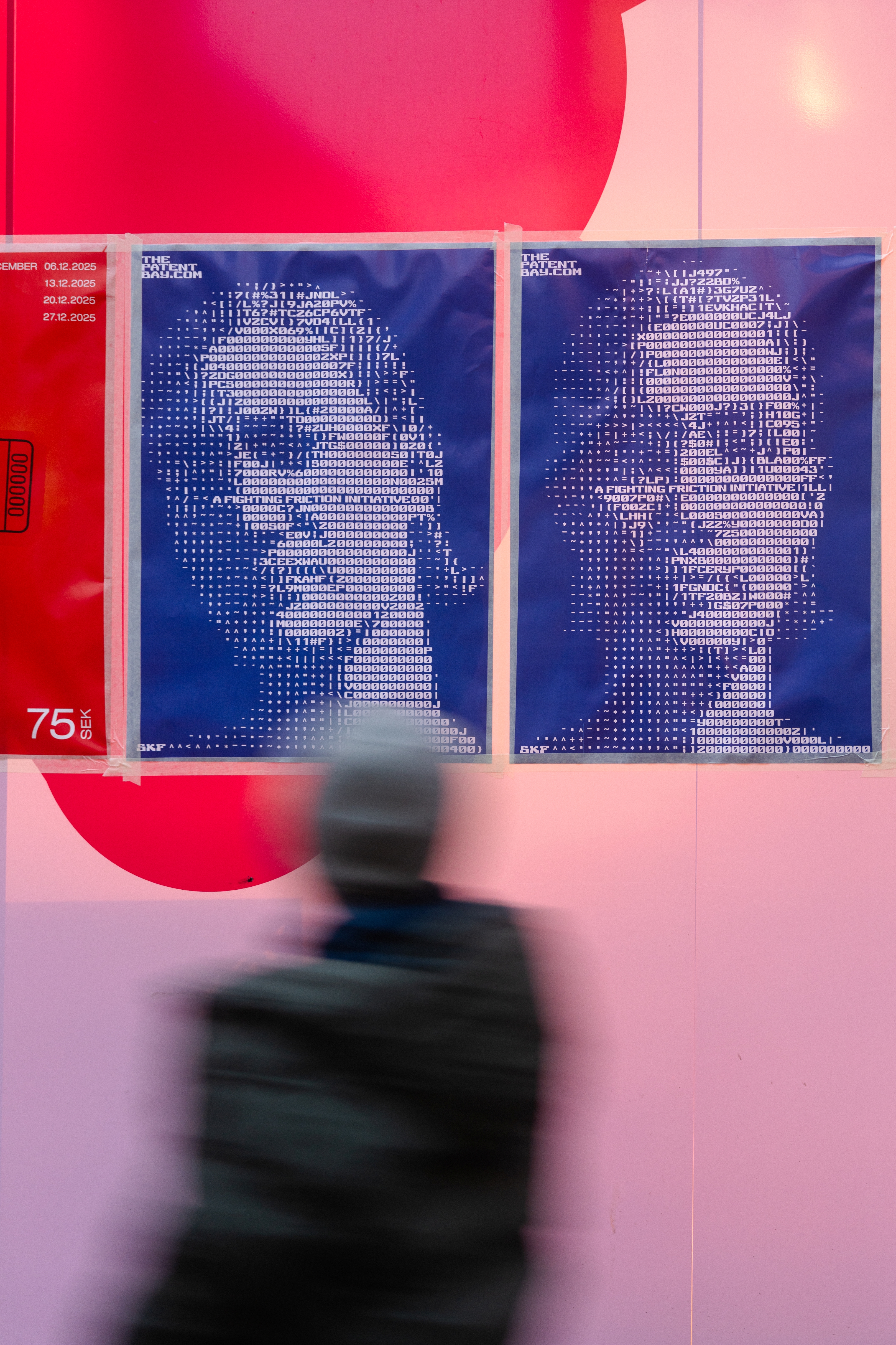 two posters for The Patent Bay on a pink and red wall, with an out-of-focus person in the foreground looking at them two posters for The Patent Bay on a pink and red wall, with an out-of-focus person in the foreground looking at them
